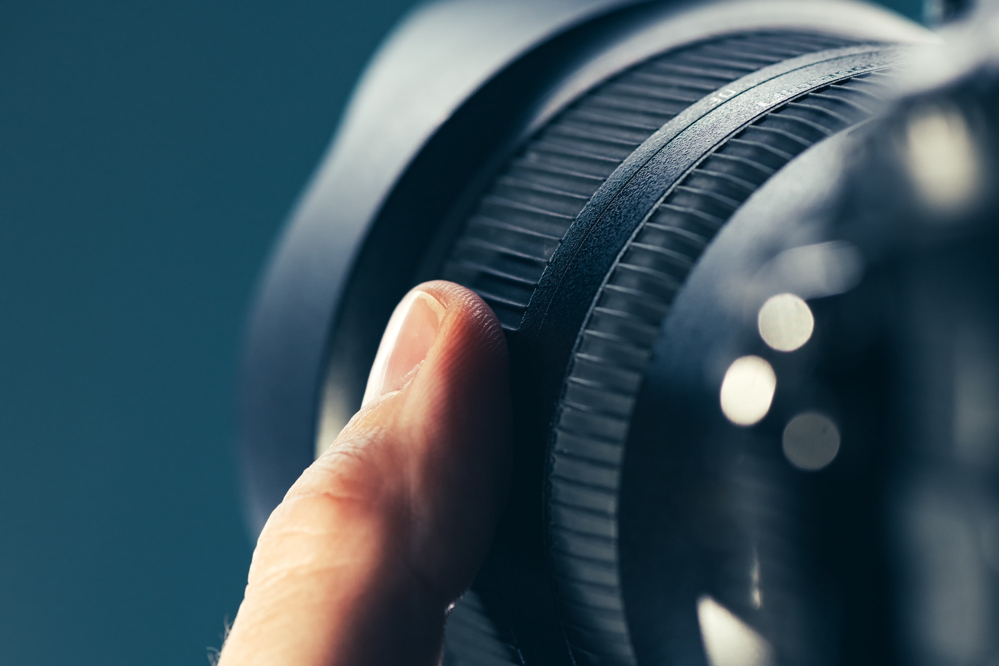 Photographer using zoom lens on DSLR camera J3 Media